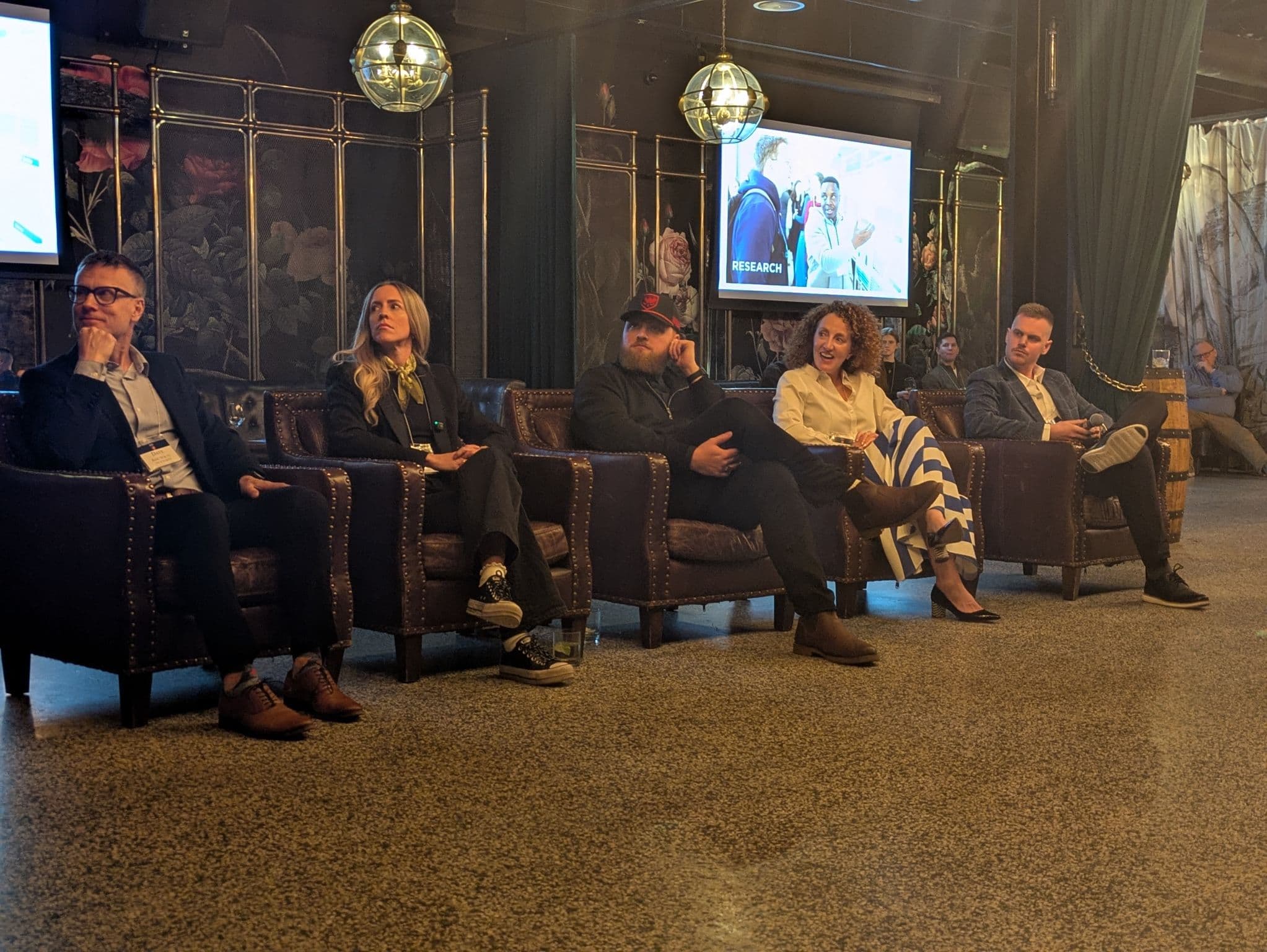 Executive panelists in a lounge-style professional event space