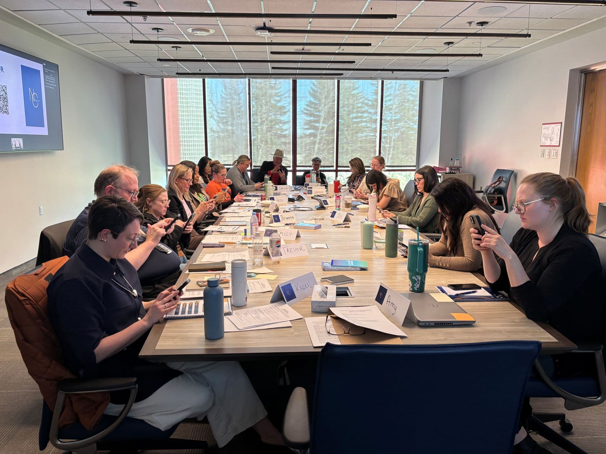 Boardroom cohort working through an immersive negotiation exercise