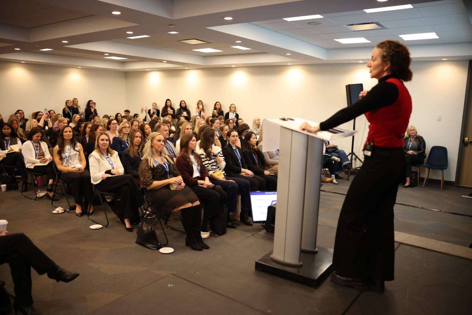 Speaker at a podium with a large attentive audience