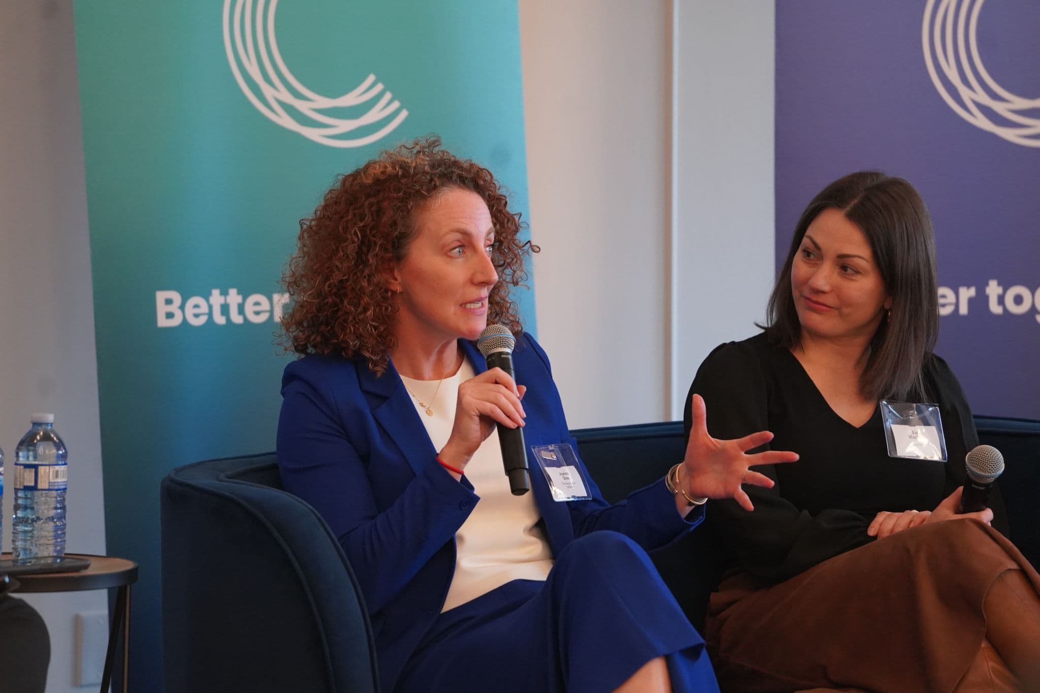 Panelist speaking with a microphone during an event