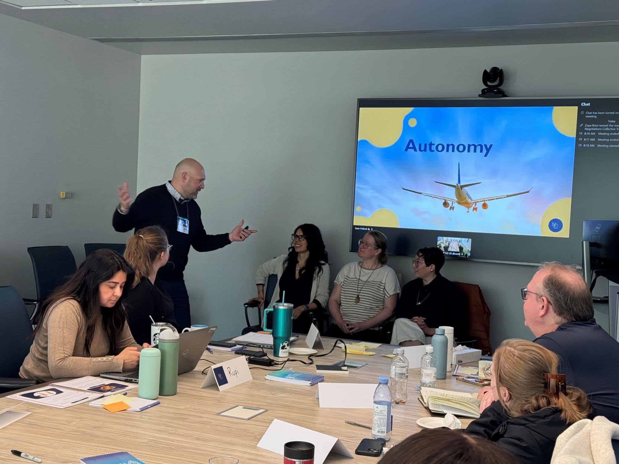 Facilitator leading a group discussion beside an autonomy slide