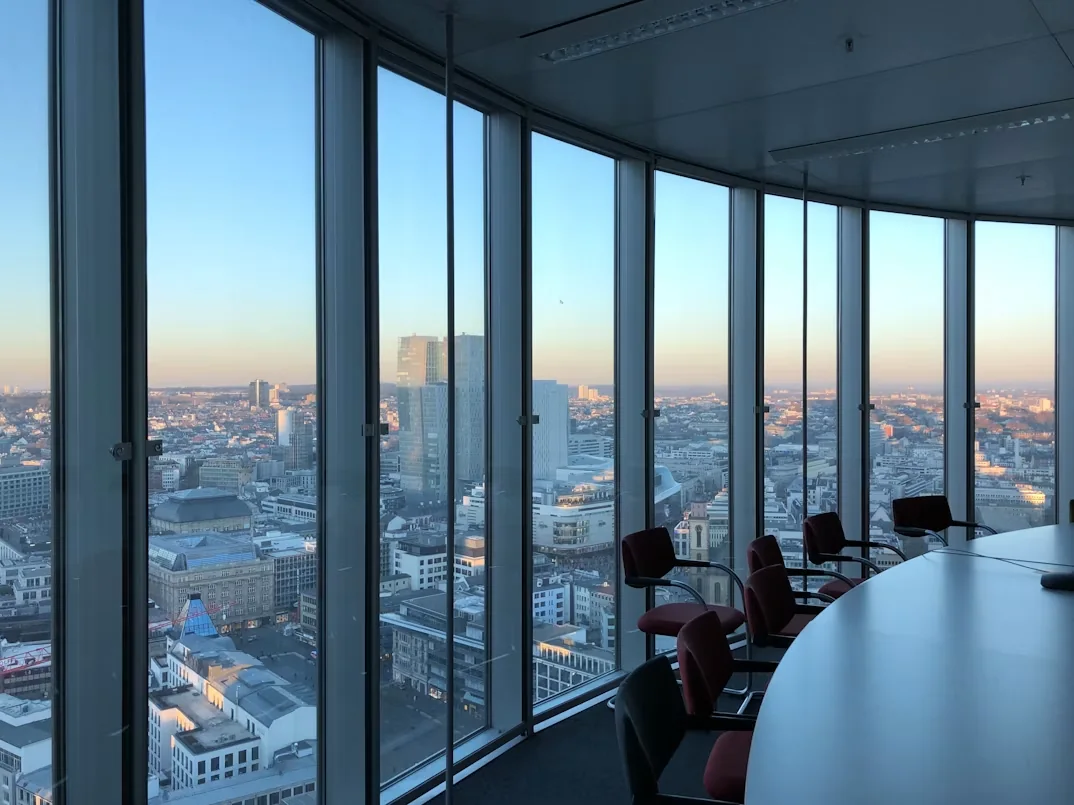 Executive boardroom overlooking a city through floor-to-ceiling windows